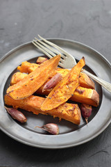 Sweet potato roasted chips on a tin plate.