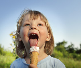 happy little boy eating an ice cream