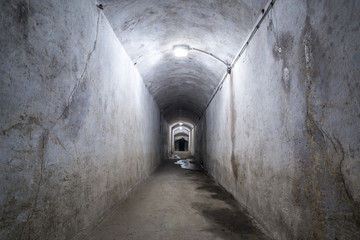 Ruined corridor with lamps.