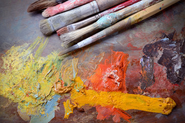 Palette with brushes and oil colors