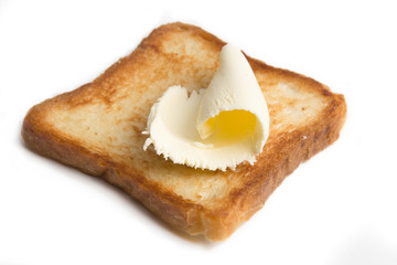 butter on a slice of toasted bread