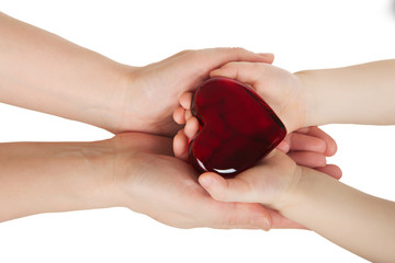 Mother's hands holding baby hands with heart