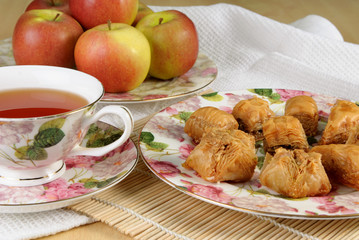 Bakhlava and tea in a flowered antique teacup