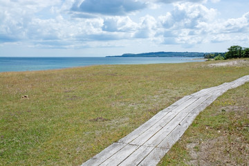 Wooden narrow boardwalk along the coast Sweden