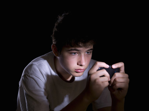 Teenager playing video games