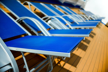 Blue sun beds lined up on deck