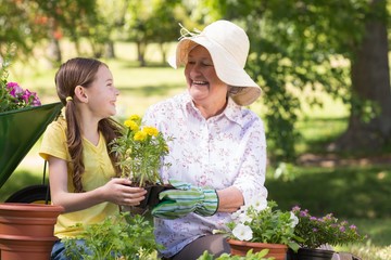Happy grandmother with her granddaughter gardening