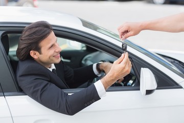 Businessman getting his new car key