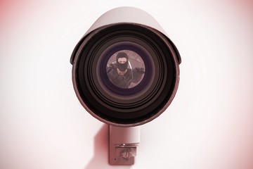 Composite image of hacker reaching out to camera