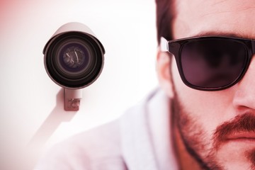 Composite image of close up of serious man wearing sunglasses