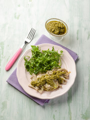 stewed meat with pesto sauce and arugula salad