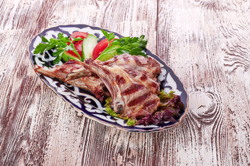 Meat on a grill with vegetables