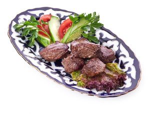 Meat on a grill with vegetables