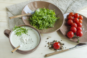 Watercress salad with cherry tomatoes and sour cream