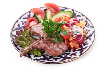 Meat on a grill with vegetables