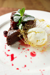 Chocolate brownie with cherries and vanilla ice cream