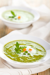 Green pea soup in bowls.