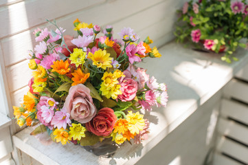 Artificial flowers in the basket in vintage theme
