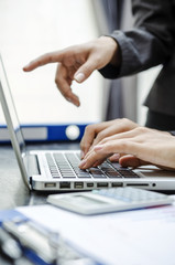 Business person pointing to laptop screen