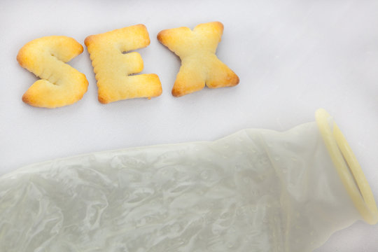 Cookies arranged in Sex Text along with Condom
