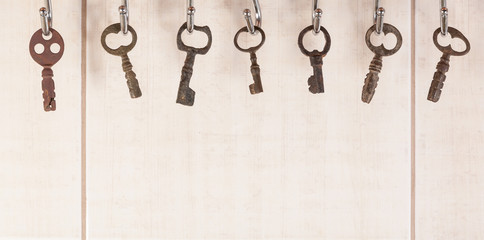 Fototapeta na wymiar Bunch of old keys hanging on wall