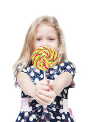 Little girl with lollipop isolated. Focus on candy