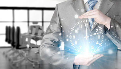 Image of businessman holding clock against illustration