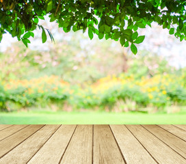 Naklejka na ściany i meble Perspective wood over blur trees with bokeh background