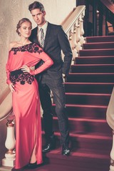 Fototapeta na wymiar Beautiful well-dressed young couple in luxury interior