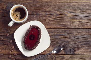 Coffee cup and cake with cherry jelly