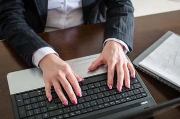 Businesswoman typing on a laptop