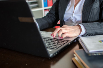 Businesswoman typing on a laptop