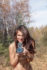 Woman in forest with camera
