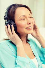 smiling woman with headphones at home