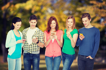 smiling students with smartphones