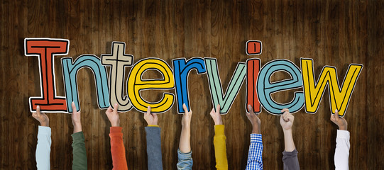 Group of Hands Holding Interview Word Concept