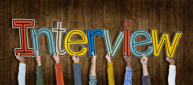 Group of Hands Holding Interview Word Concept
