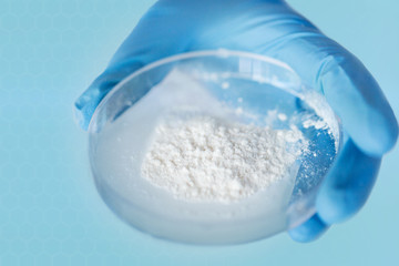 close up of scientist hands holding petri dish