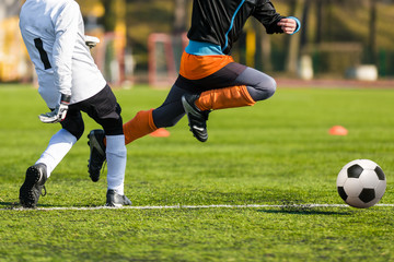 Football soccer match for children. Boys playing football