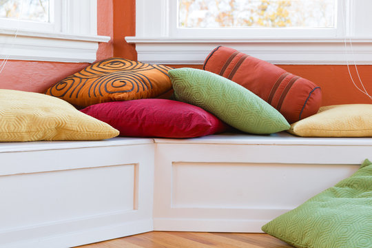 Window seat with cushions. Colorful and cheerful.