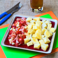 Cooked cassava  with corn, onion and tomato