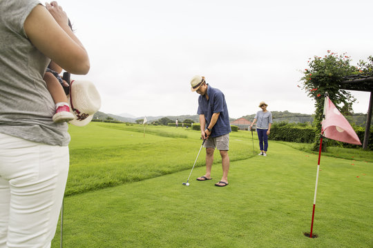 Family On A Golf Course.