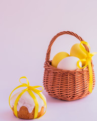 Easter cake and easter eggs in the basket on a white background.