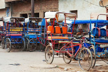 Fototapeta na wymiar Many bicycle rickshaws on parking