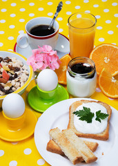 Breakfast with coffee,  eggs,  orange juice, muesli, yogurt