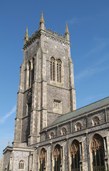 Fototapeta na wymiar A Tall Tower on a Traditional Church Building.