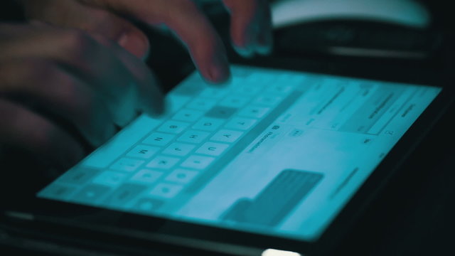 Male Hands Typing on a Tablet Computer, closeup