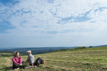 Senior couple sitting in the field