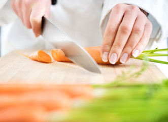 Obraz na płótnie Canvas Chef chopping carrot