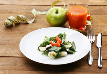 Salad with quail egg and basil in plate